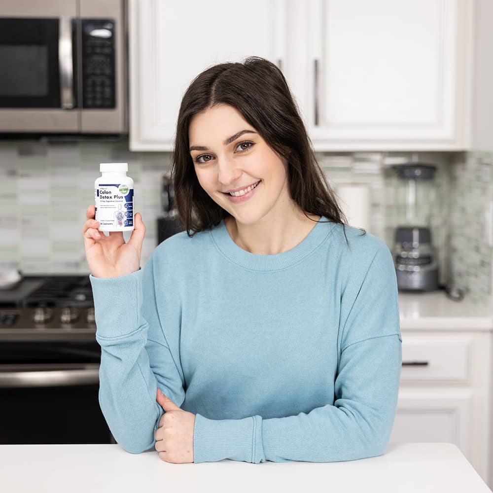 A happy woman celebrating with open arms, symbolizing the benefits of a healthy gut.